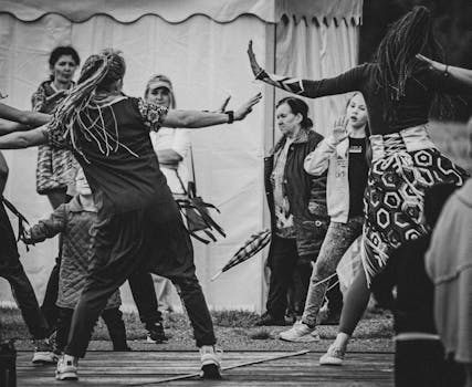 A lively scene of people dancing outdoors, showcasing cultural expression.