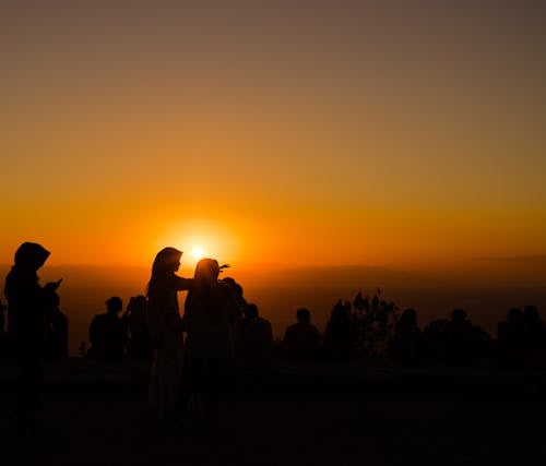 Silhouette Photograph of Several People during Golden Hour
