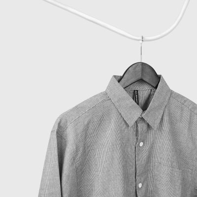 Grey cotton shirt on a hanger — photo by Fahmi Garna on Pexels