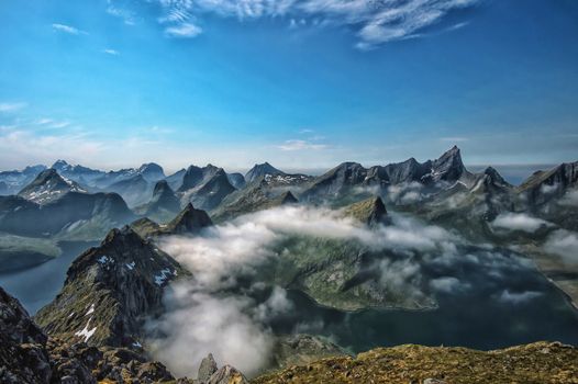 Explore the stunning peaks and misty landscapes of the Lofoten mountains in Norway.