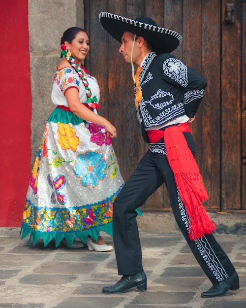 Free Man and Woman in Traditional Clothes Dancing Stock Photo