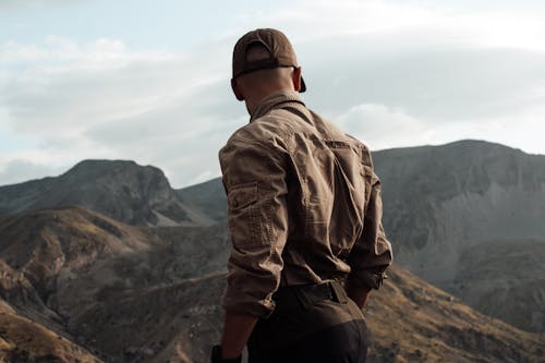 Man Standing and Looking at the View of Mountains 