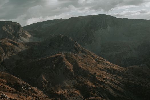 A breathtaking view of rugged mountains under a moody sky.