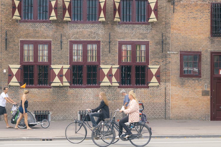 People Walking And Cycling In Town