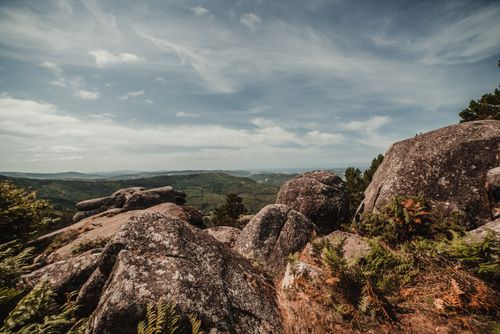 Free Explore a stunning rocky landscape under a vibrant blue sky with fluffy white clouds. Stock Photo