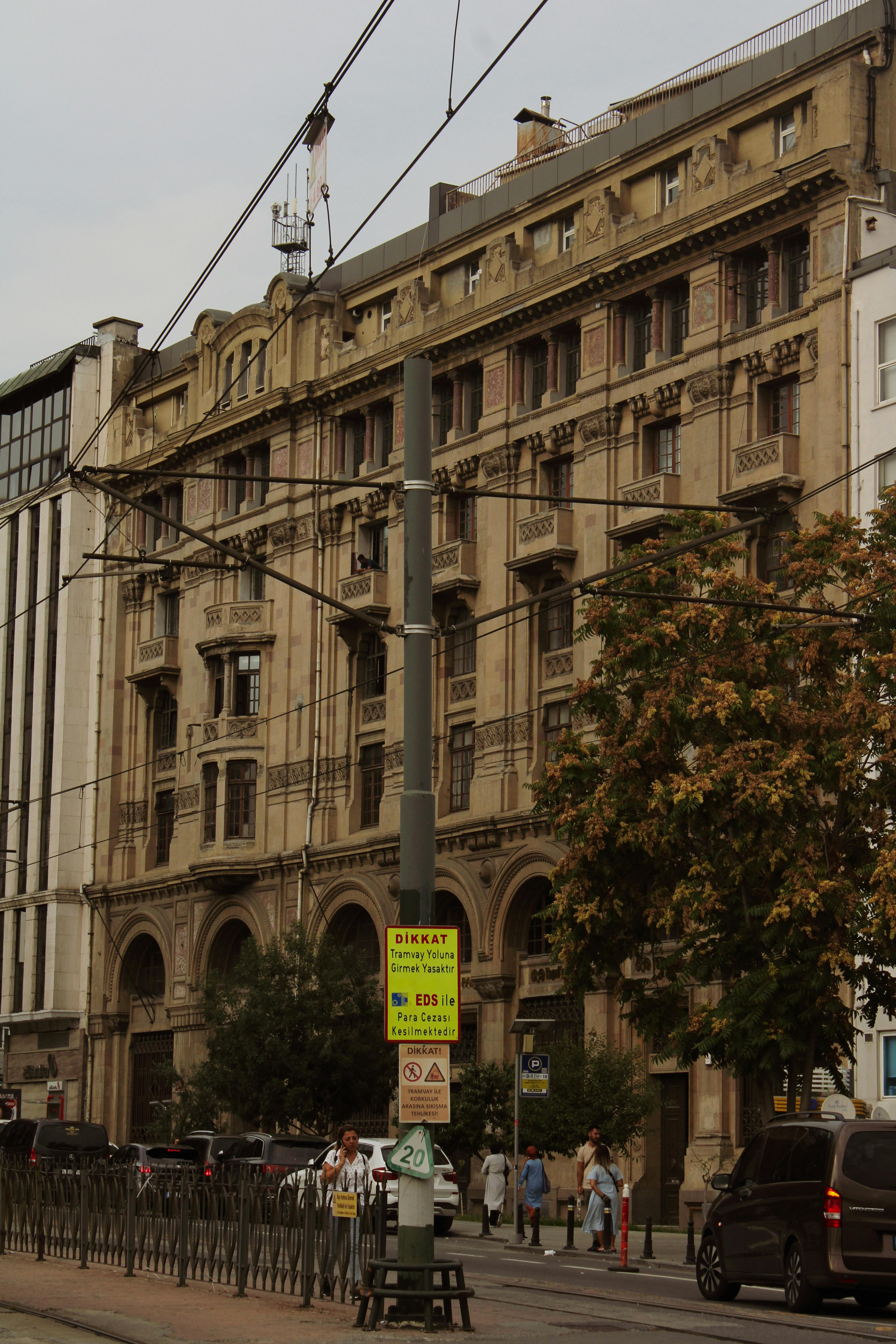 Vintage building facade captured on a bustling city street, showcasing urban life.