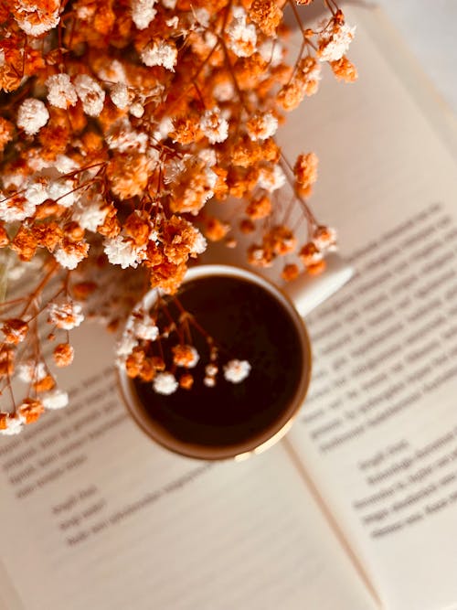 White and Brown Flowers on a Book