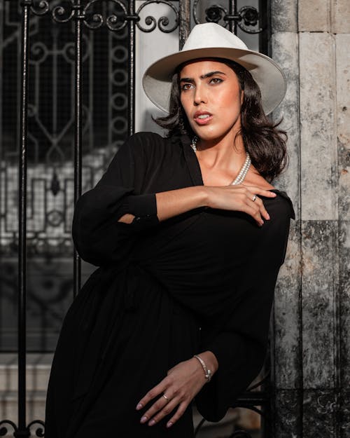 A Woman in Black Long Sleeve Dress Wearing White Hat