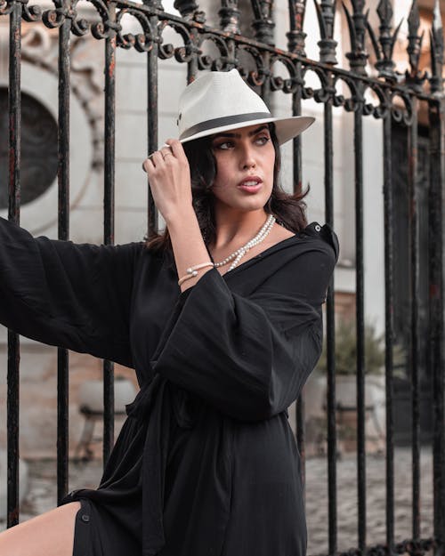 A Woman in Black Dress Posing at the Camera