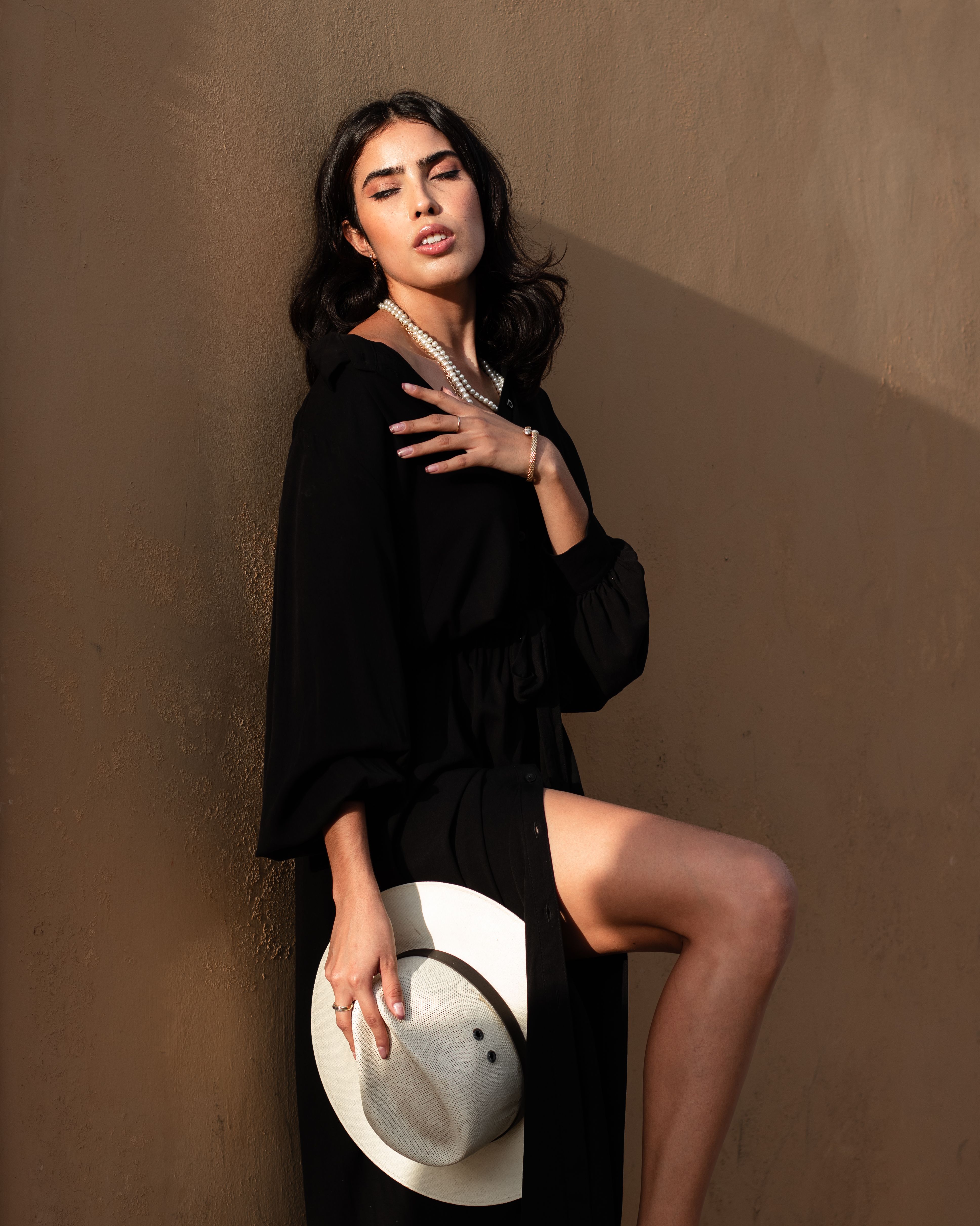 Close-Up Shot of a Beautiful Woman in Black Dress Holding a Fedora Hat ...