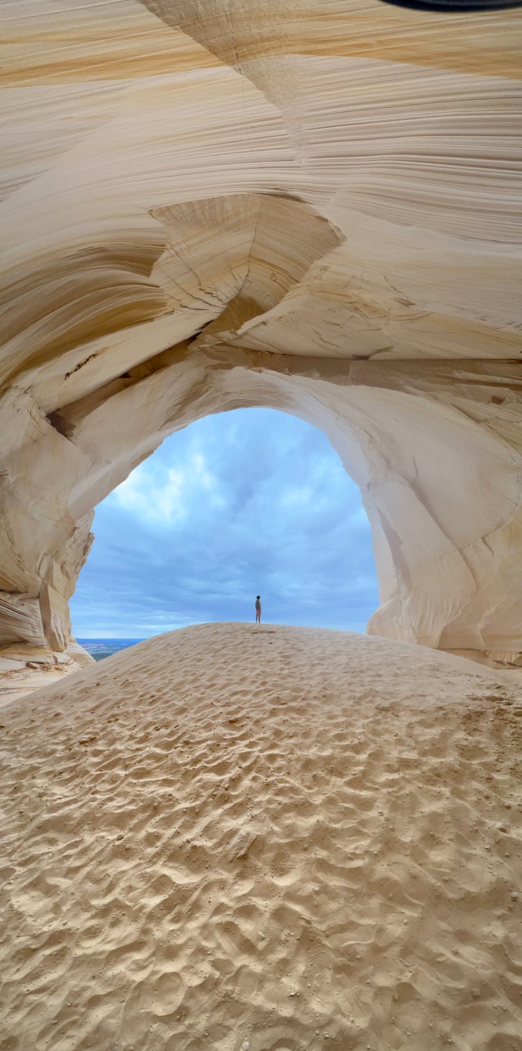 Person Standing By Cave Entrance