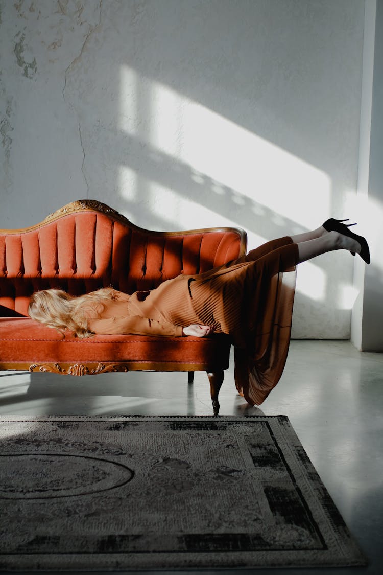 Exhausted Woman Lying On Sofa