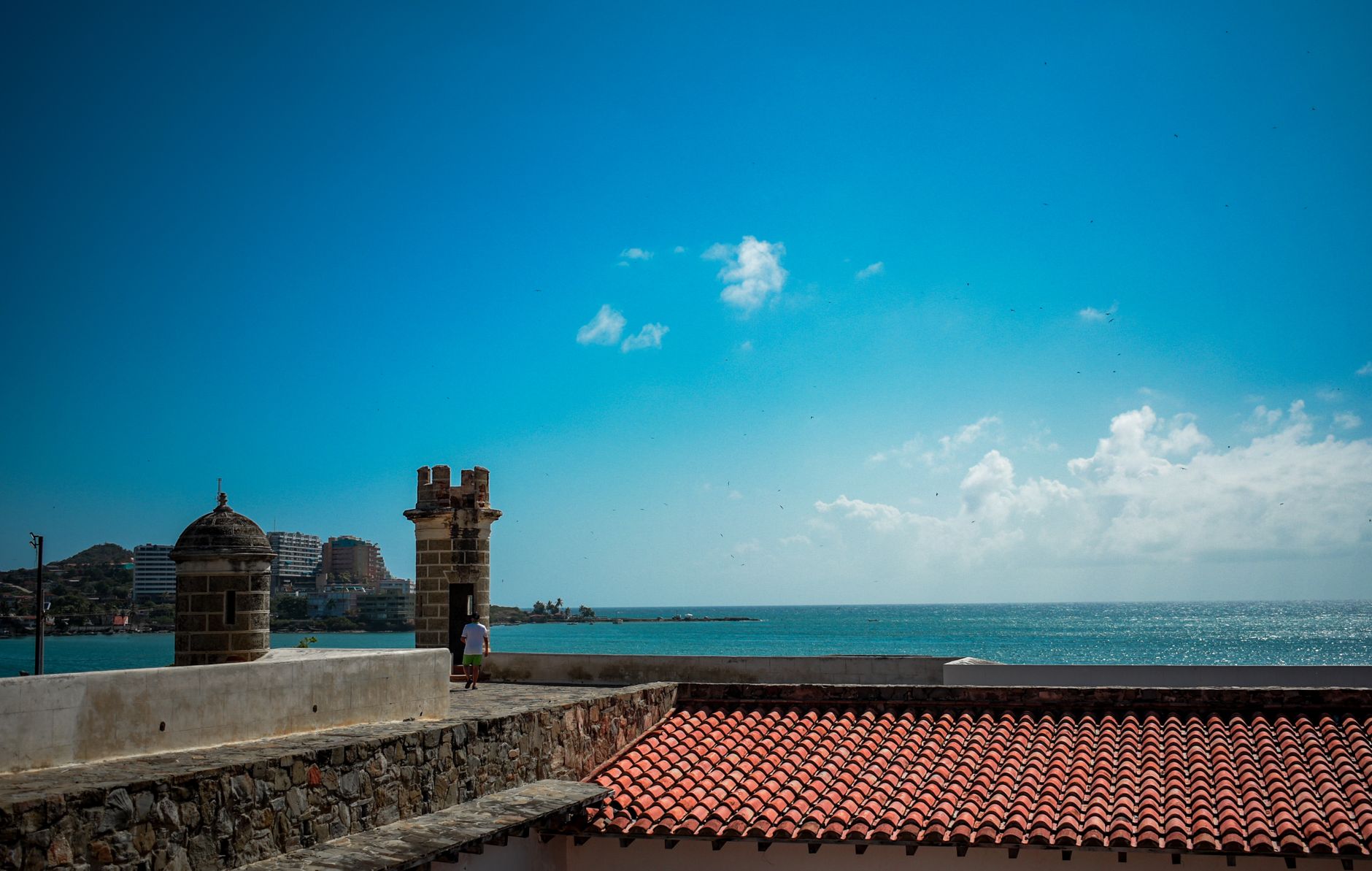 Vibrant coastal scene with historic architecture and ocean views in Venezuela.