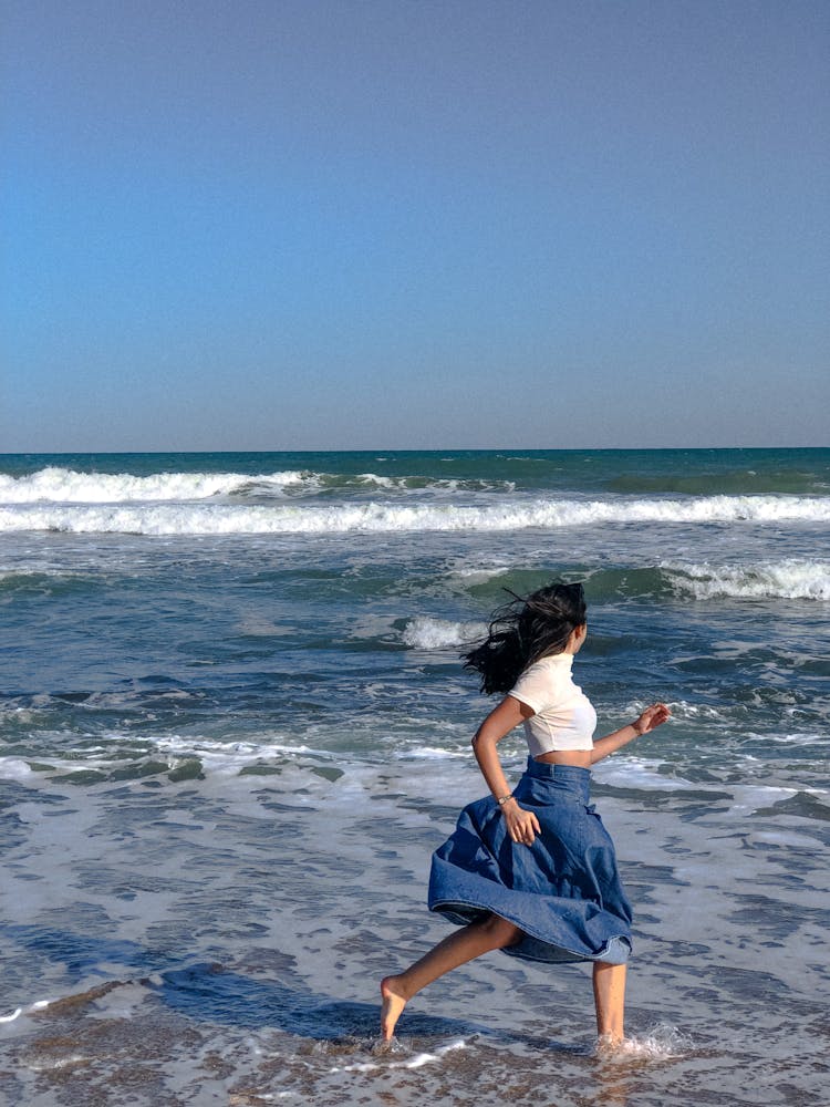 Woman Running On The Beach