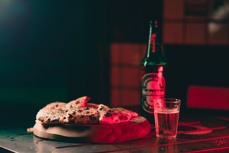 Flat Bread On Cutting Board Next To Beer Bottle