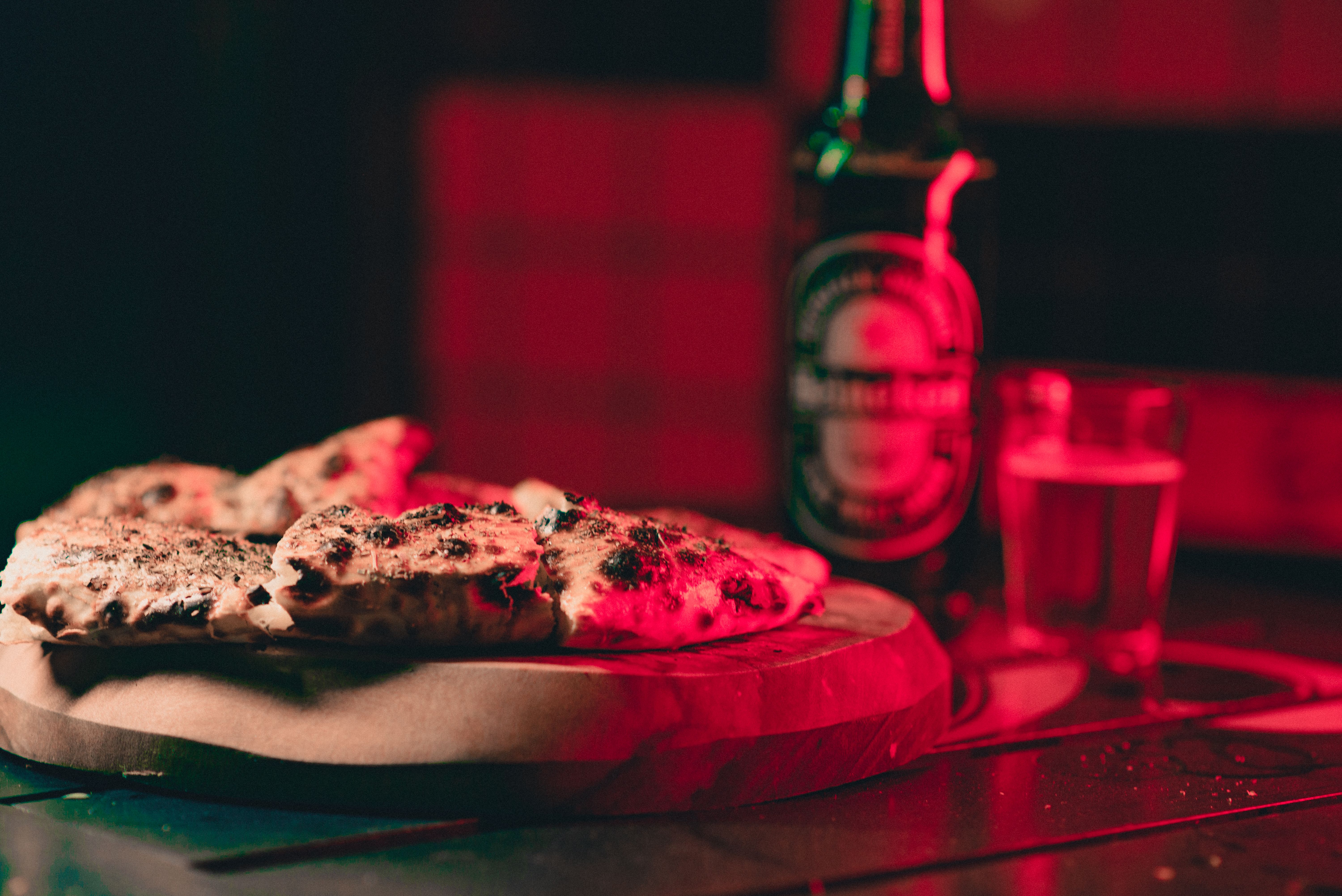 Pizza being slid onto a preheated pizza stone in an oven