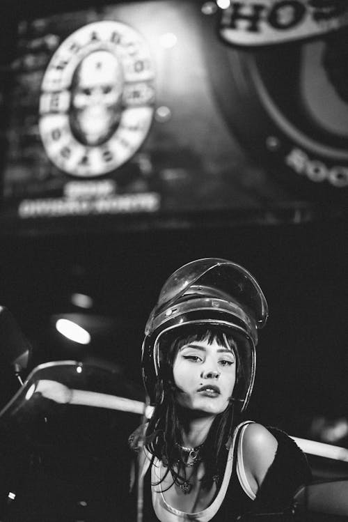 Grayscale Photo of a Woman Wearing Helmet