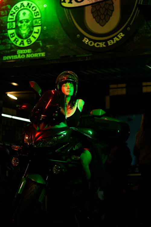 A Woman Sitting on the Black Motorcycle