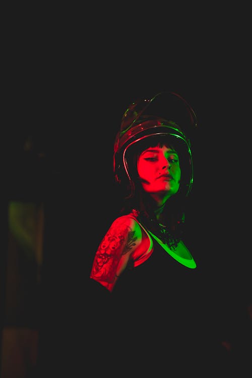 Woman in Tank Top Wearing a Motorcycle Helmet