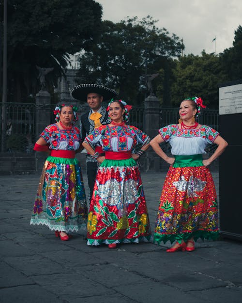 Women in Floral Dresses Standing on the Road