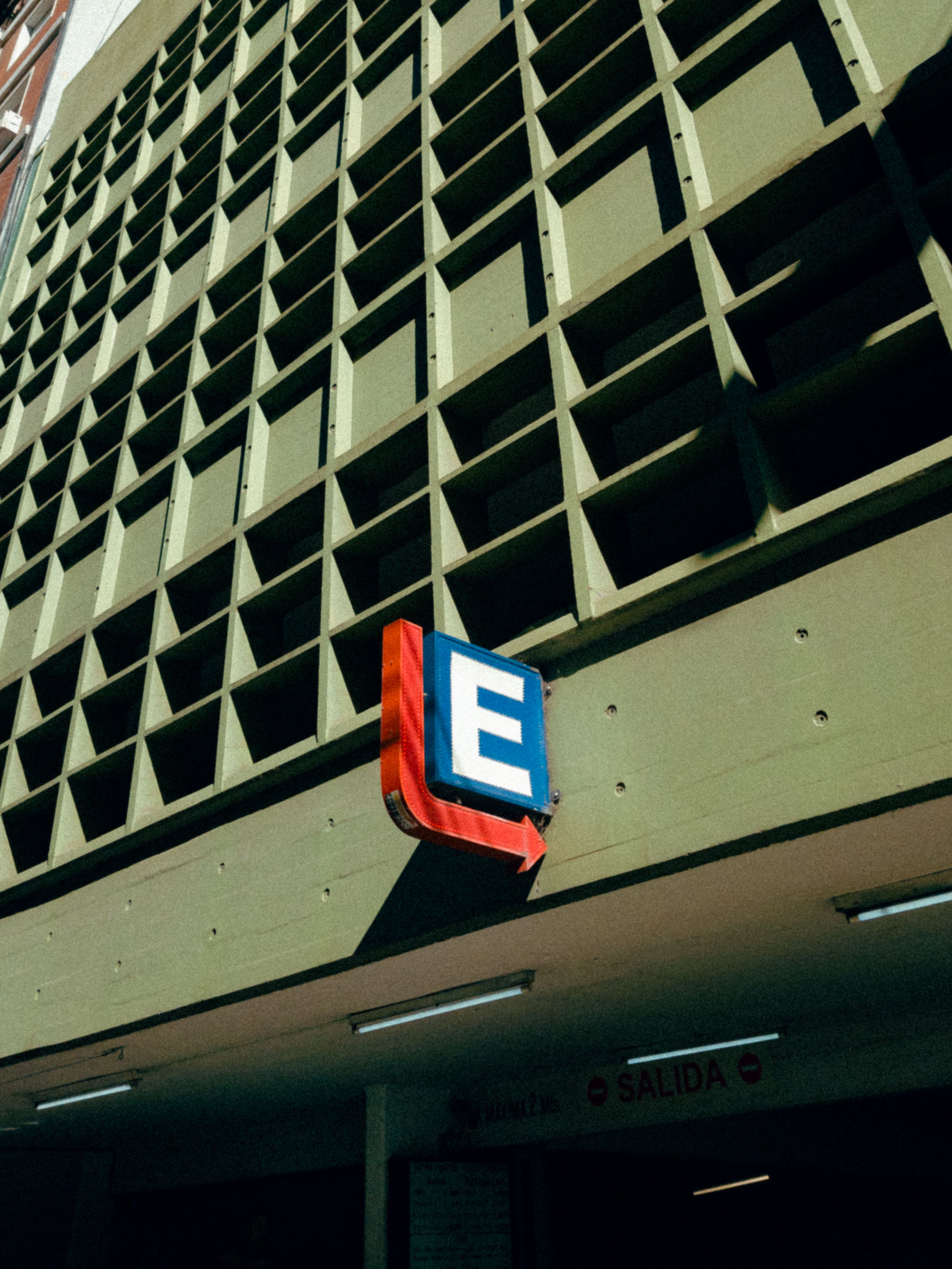 Parking sign at building facade in Buenos Aires, Argentina, under clear sky.