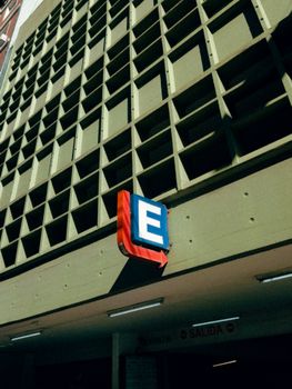 Parking sign at building facade in Buenos Aires, Argentina, under clear sky.
