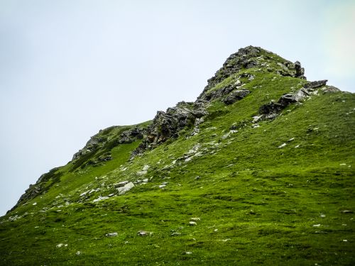 Free A vibrant green mountain peak under a clear sky showcasing natural beauty. Stock Photo