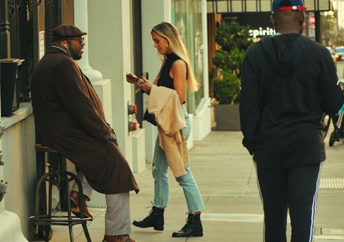 Free Candid moment of people interacting on a city sidewalk during the day. Stock Photo