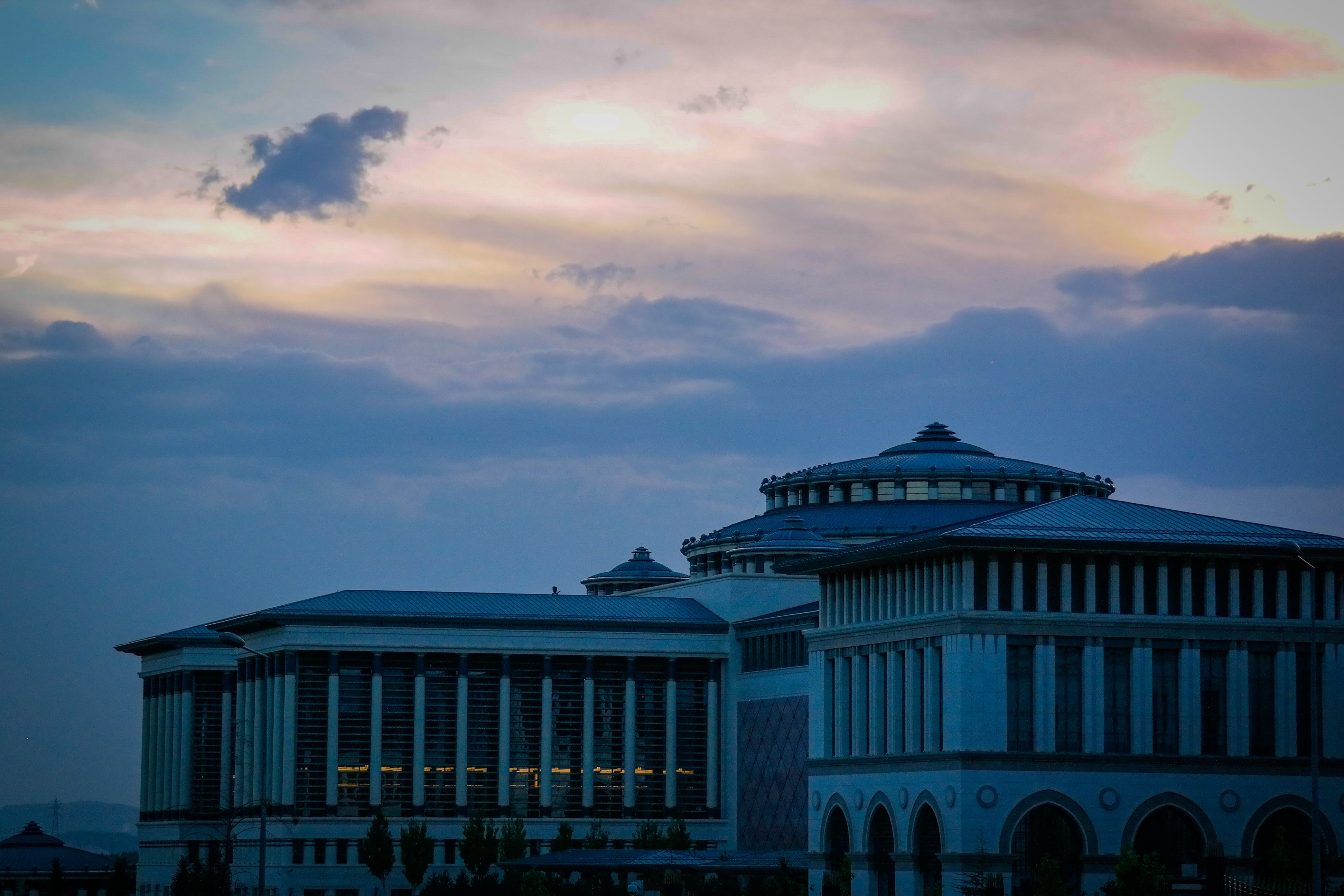 The exterior of a diplomatic embassy building at dusk
