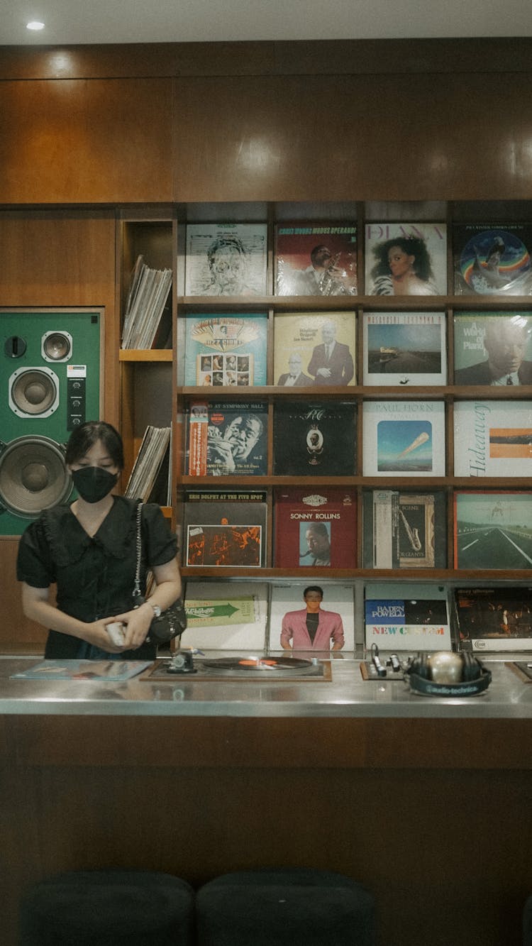 Woman In Store With Vinyl Records