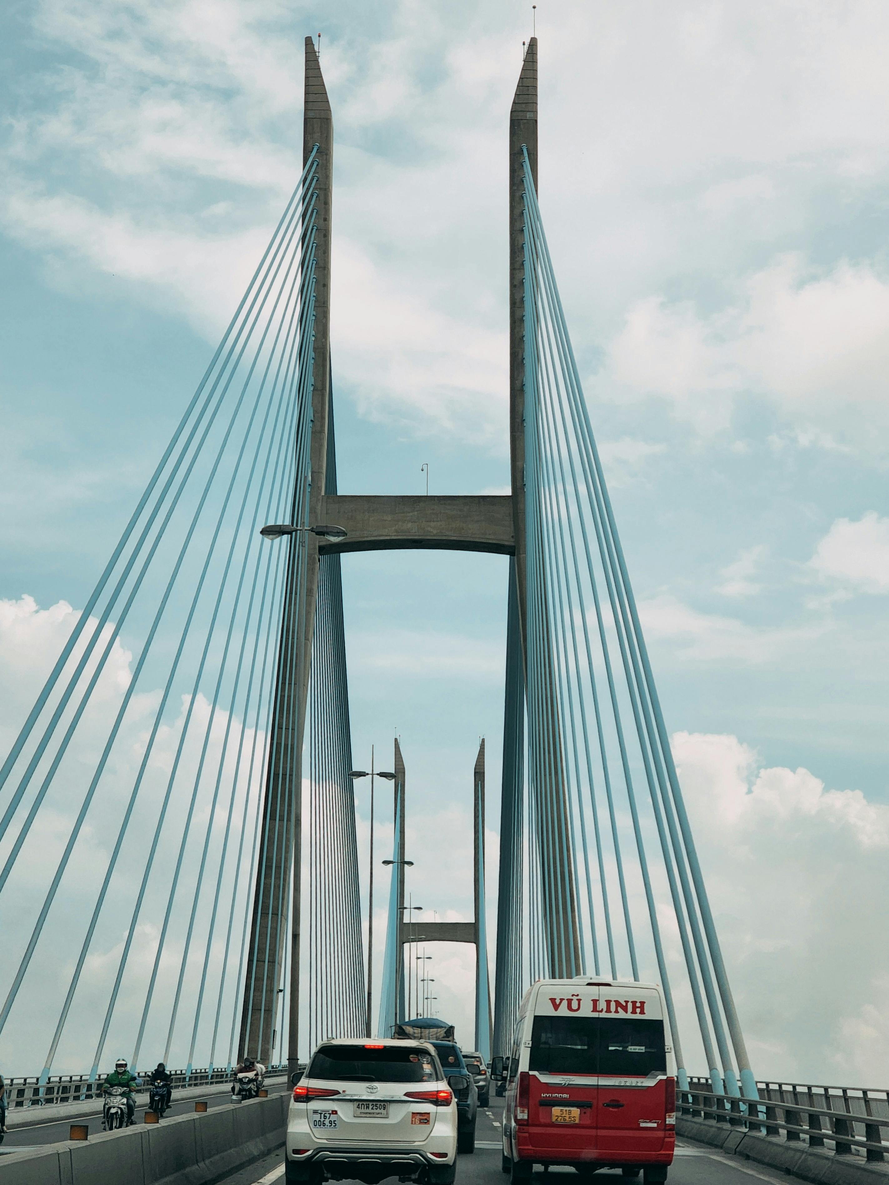 white bridge under white clouds