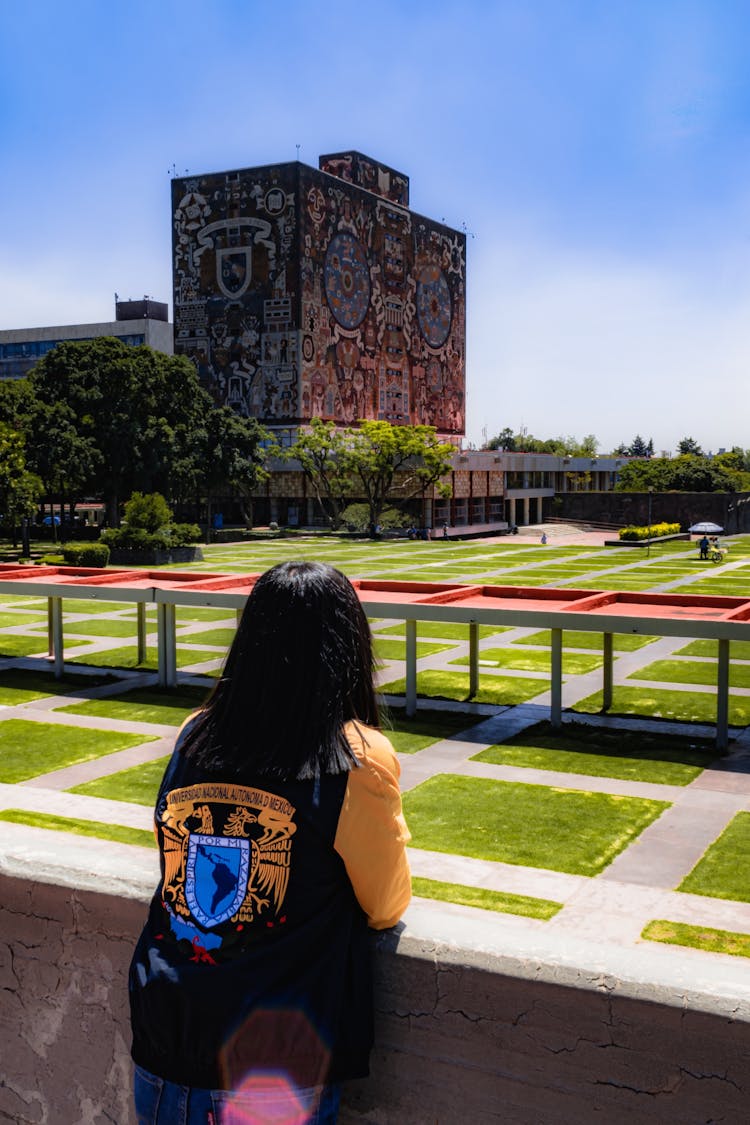 Woman Looking At The Building Of National Autonomous University Of Mexico