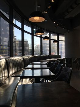 Sunlit coffee shop interior with empty tables and modern design in Taipei.