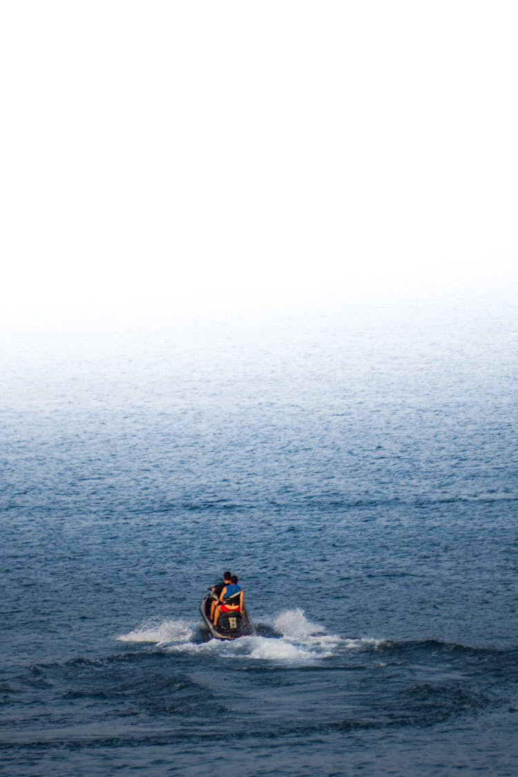 People Riding Jetski On Sea