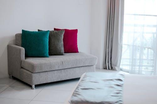 Red Throw Pillow on Gray Fabric Chaise Lounge Near Gray Window Curtain