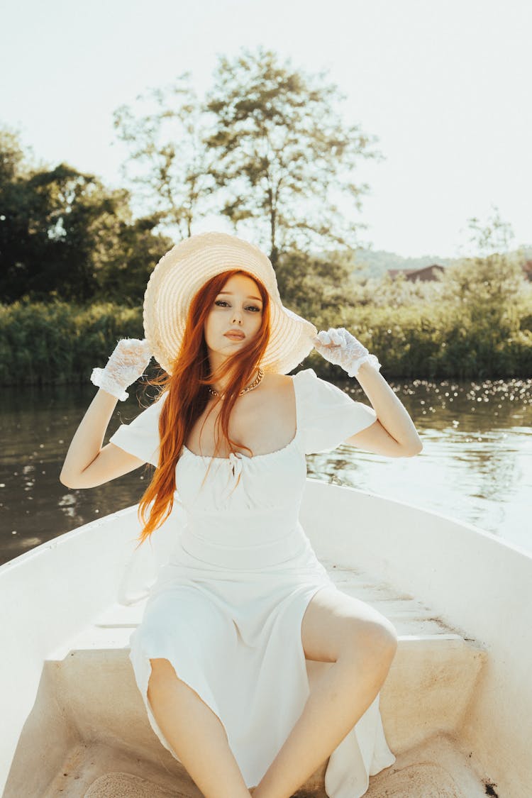 A Woman In White Dress Sitting On A Boat