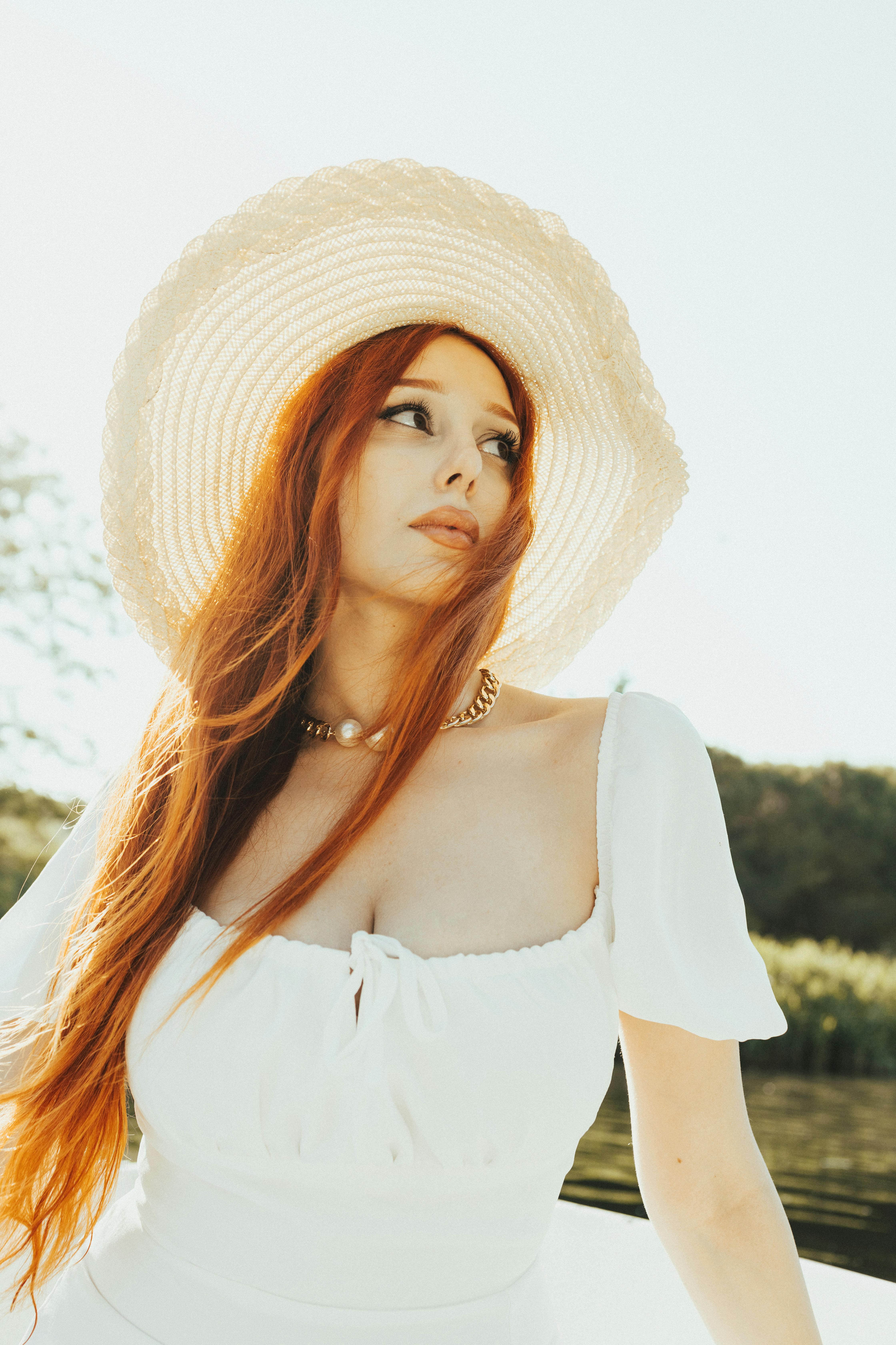 Free A contemplative moment captured by the Bosphorus with a woman in a sun hat. Stock Photo