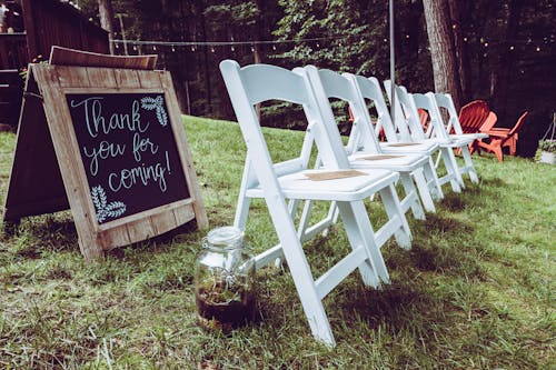 Empty White Wooden Folding Chairs