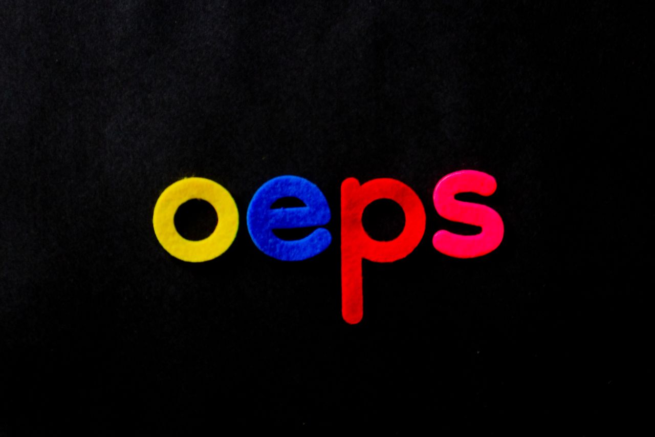 vibrant colored letters spelling oeps on a black background