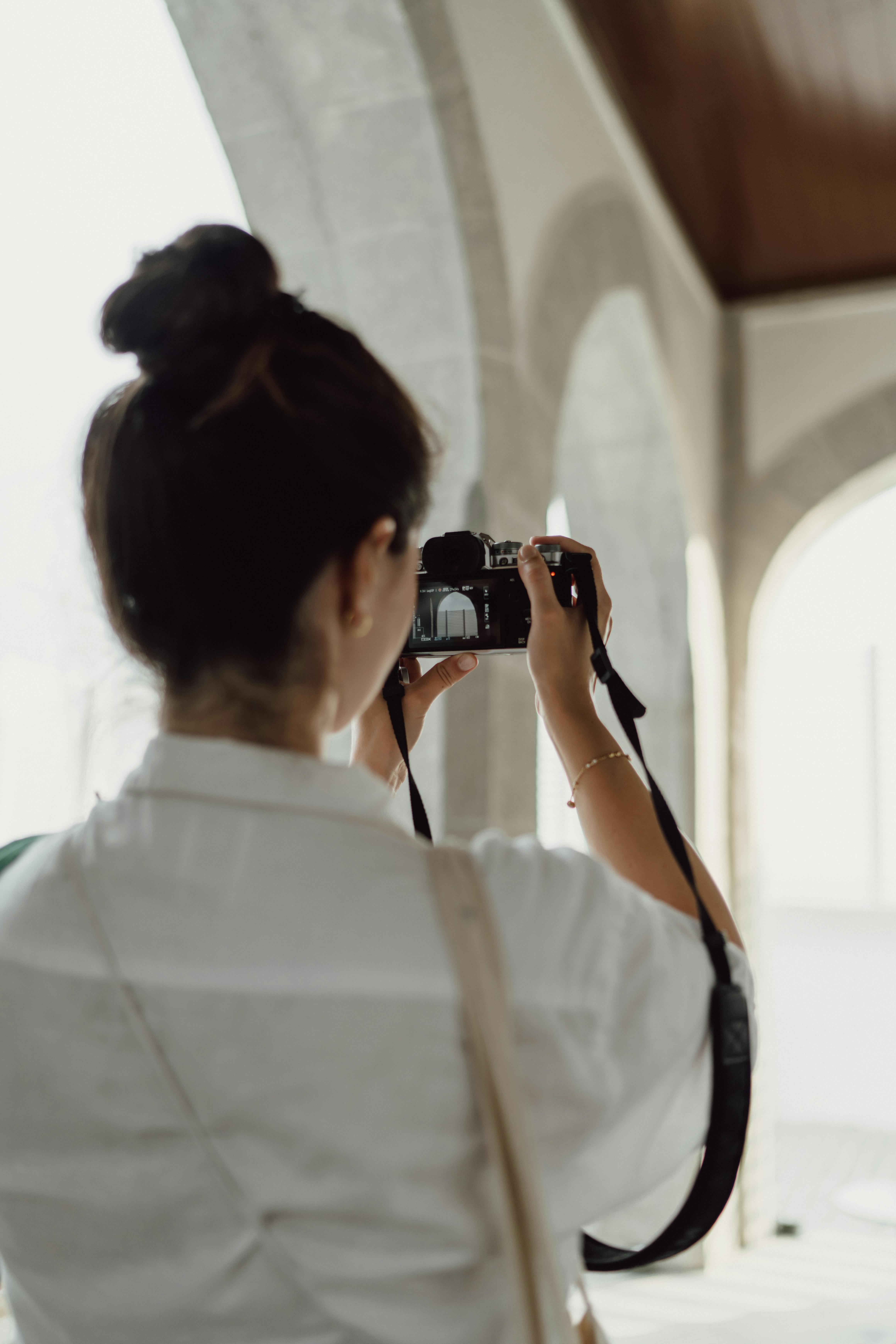A woman capturing a photo at a historic site in Istanbul, Türkiye.