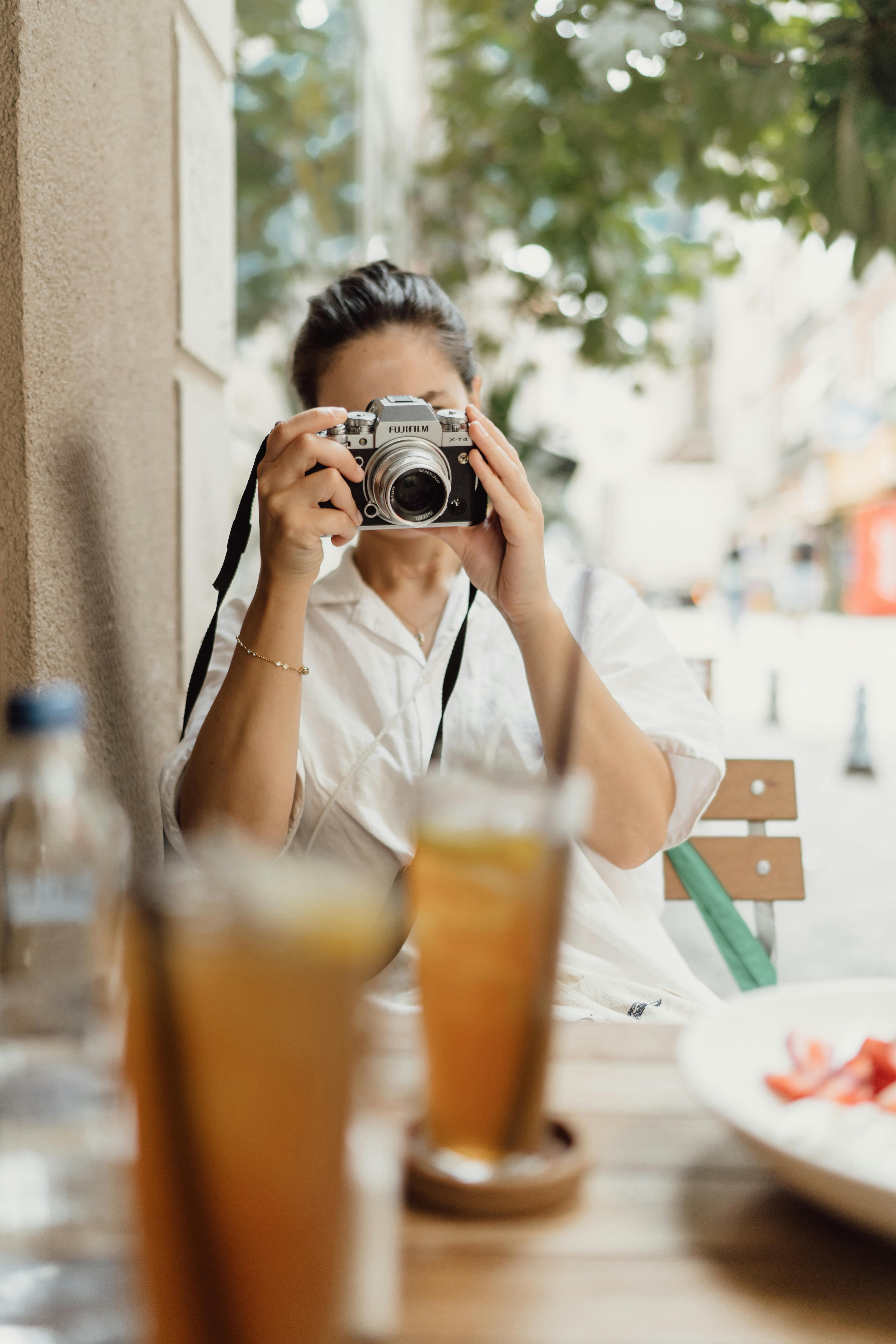 woman taking a picture of food