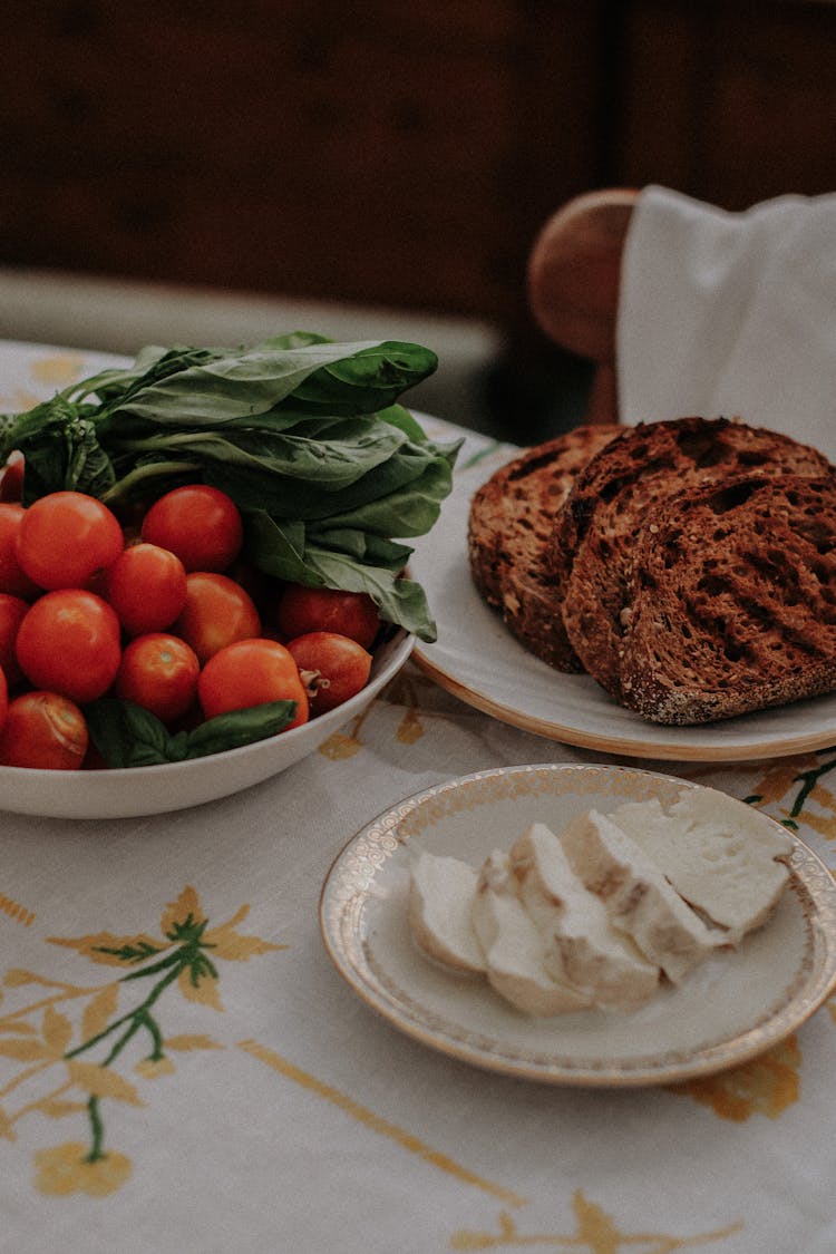 Roasted Bread, Cottage Cheese, Tomatoes And Leaves Of Spinach On A Table