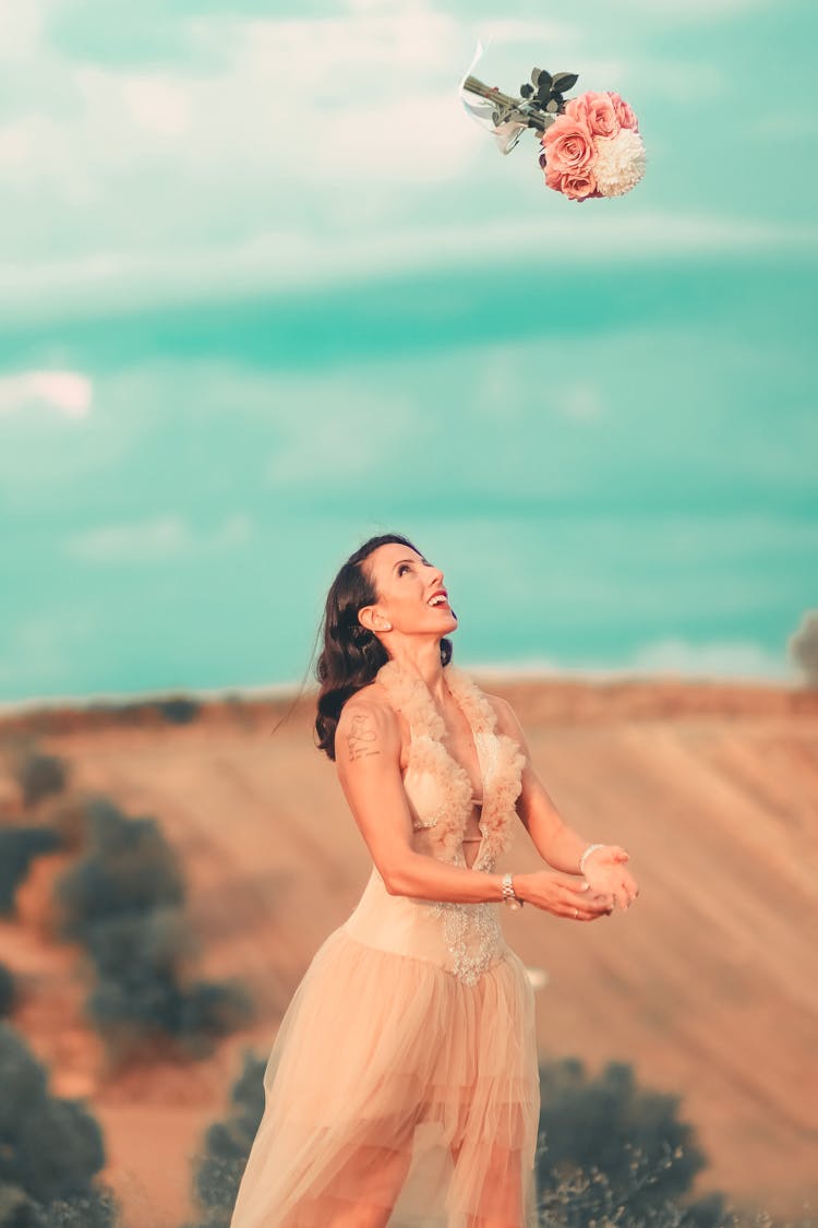 A Woman Throwing The Bouquet Of Flowers