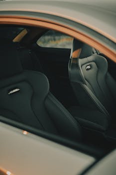 Close-up view of a luxury sports car interior featuring sleek leather seats with stylish design.