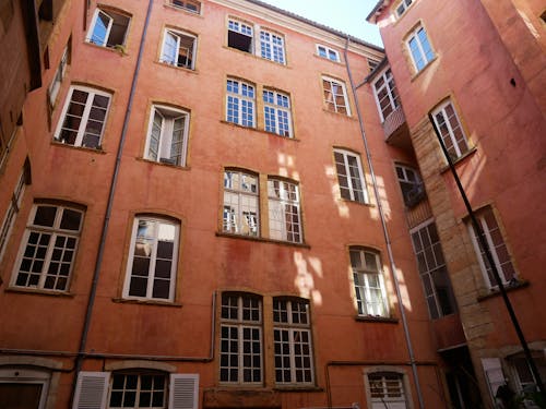 Low Angle Shot of a Brown Building with Windows