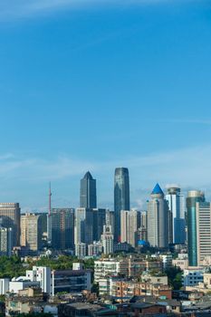 A modern city skyline featuring skyscrapers against a clear blue sky, showcasing urban architecture.