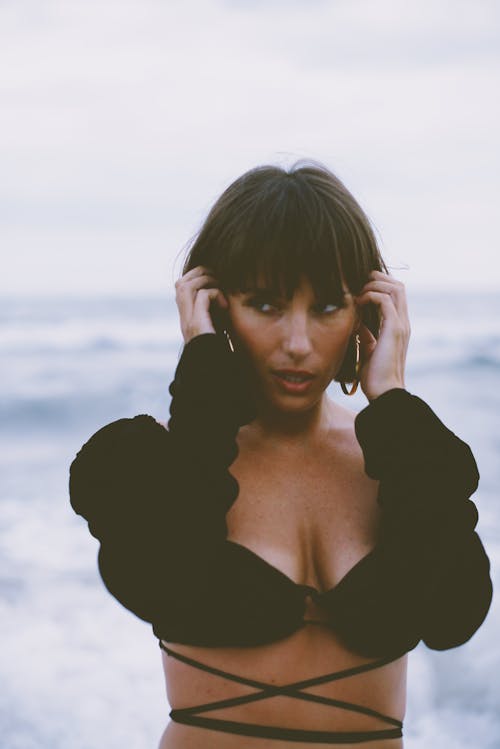 Portrait of a Brunette Woman with a Fringe on a Seashore 