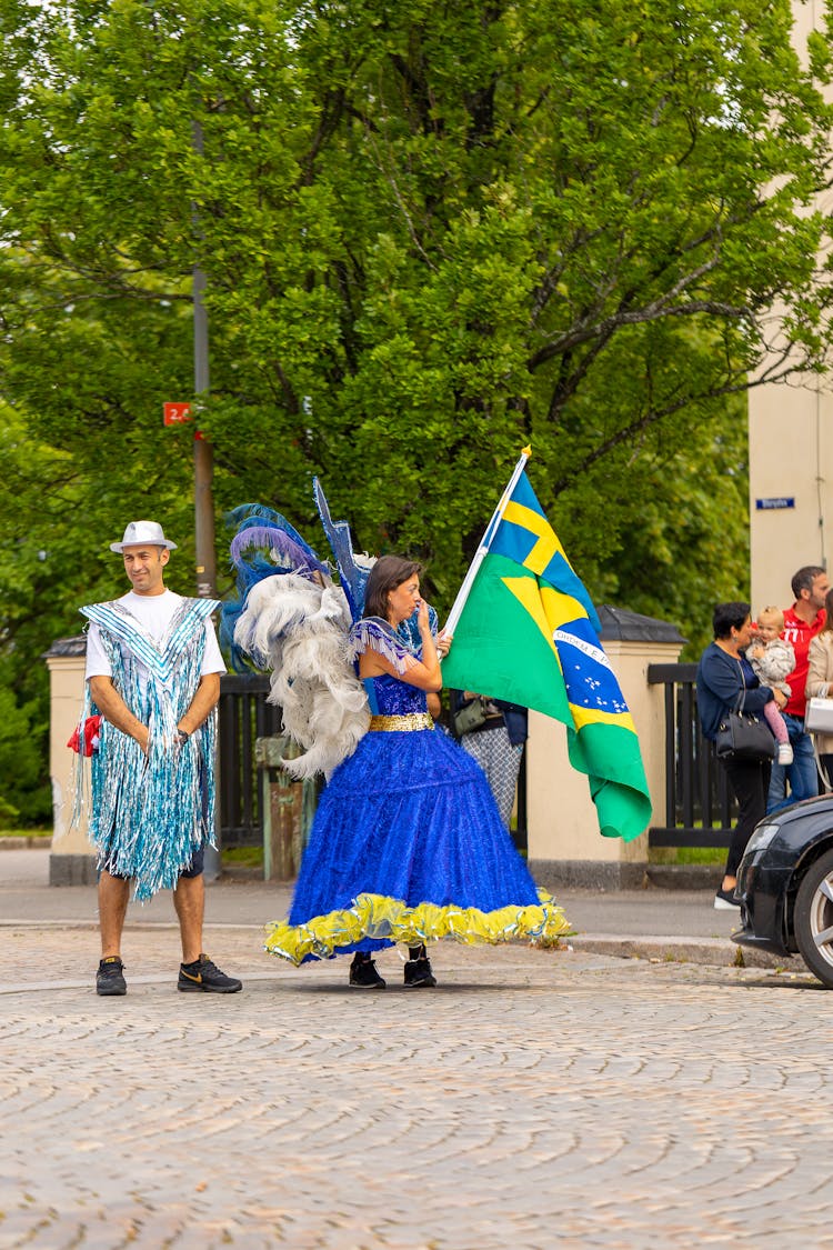 People Wearing Costumes In A Street Parade