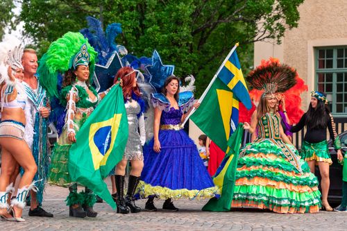 People in Costumes Holding a Brazilian Flag and Celebrating on the City Street Free Stock Photo People in Costumes Holding a Brazilian Flag and Celebrating on the City Street Free Stock Photo