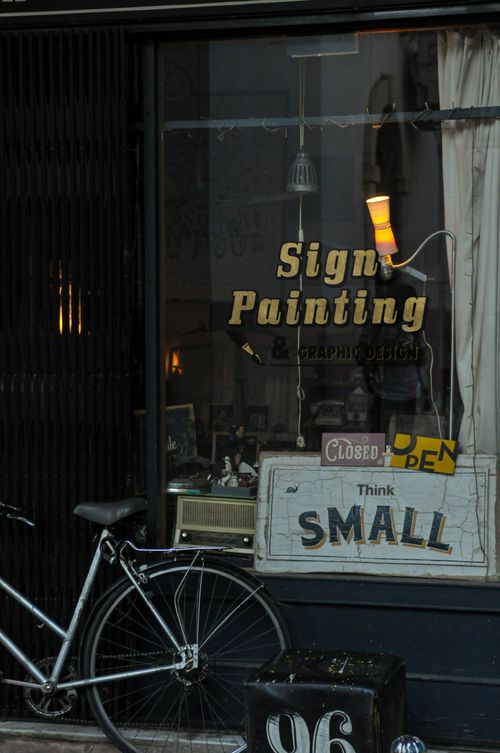 Free A quaint storefront featuring a bicycle and vintage sign designs. Stock Photo